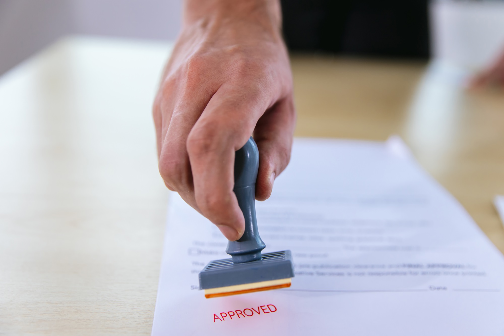 A paper with an approved stamp.