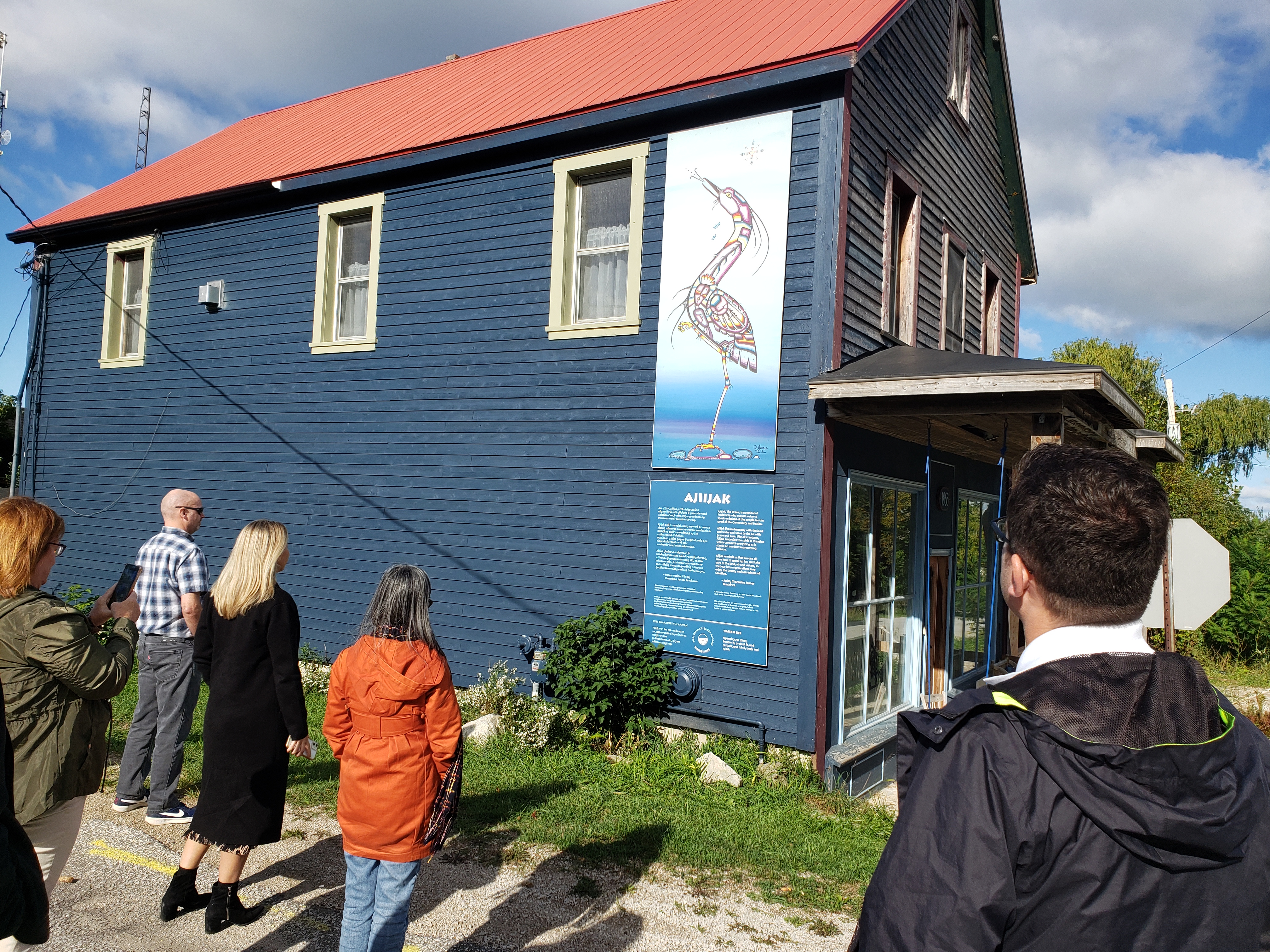 People viewing the Ajiijaak indigenous art installation in Oxenden.
