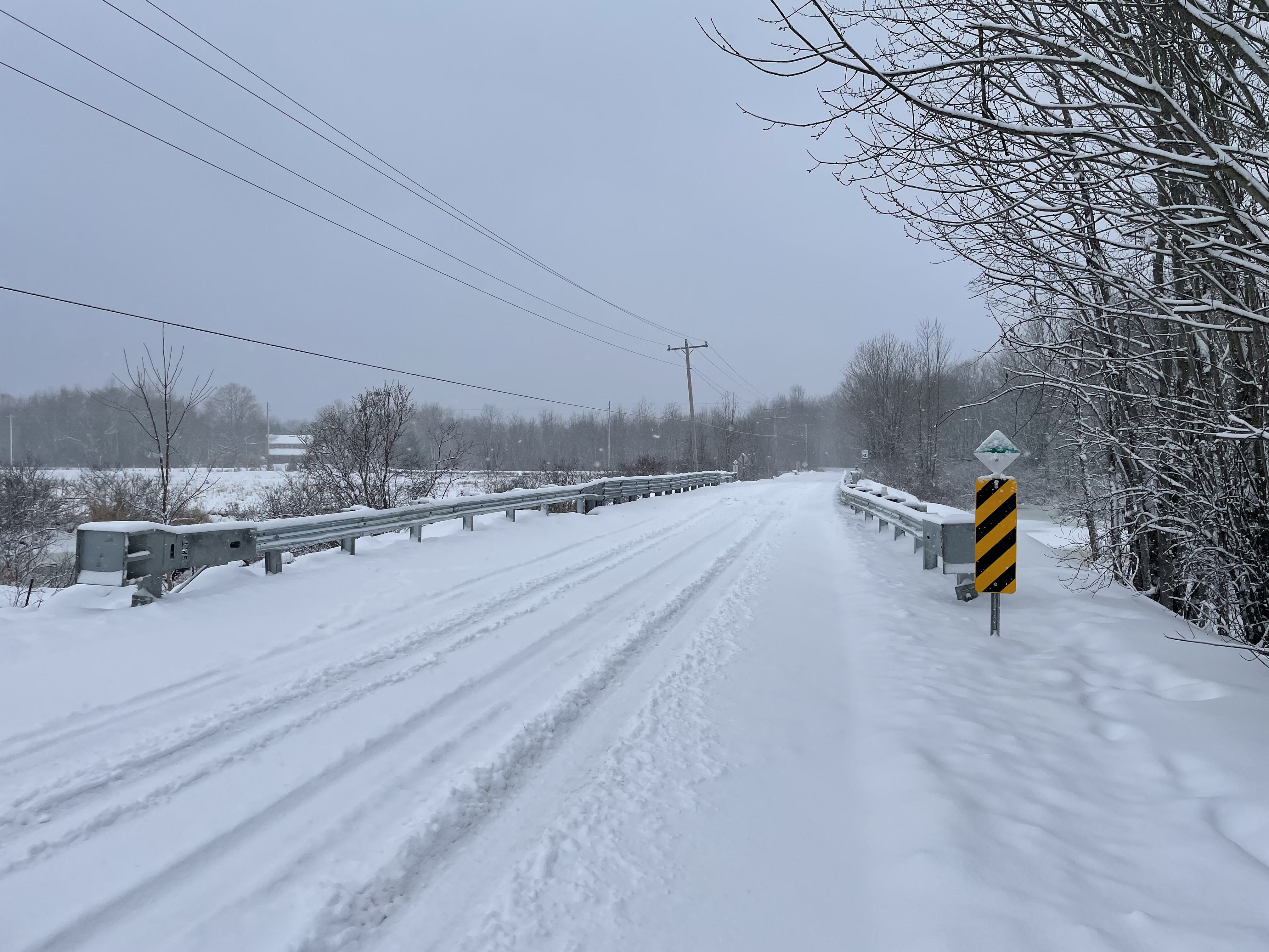 a newly reconstructed bridge, blanketed by snow,