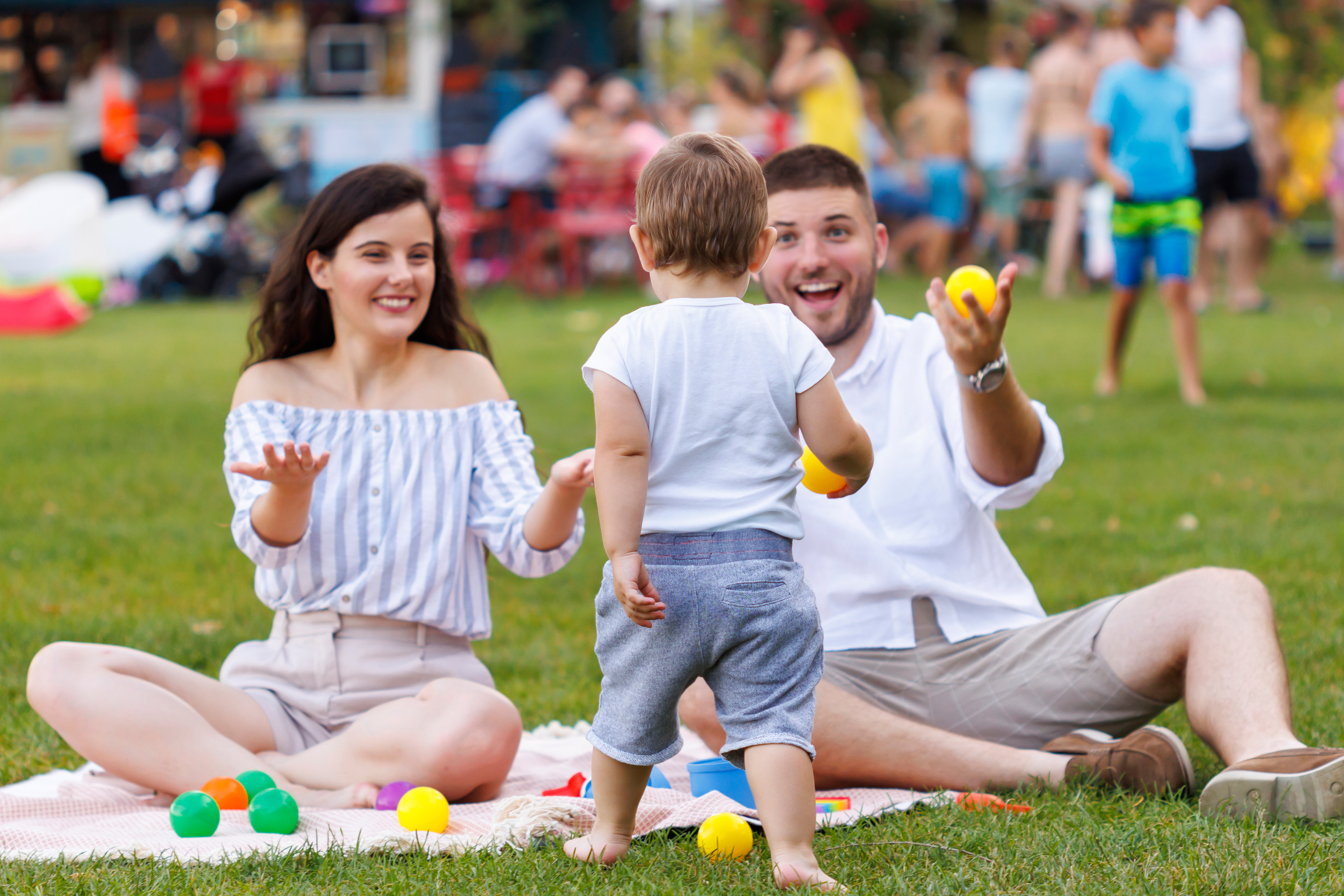 Child running towards his parents during a picnic