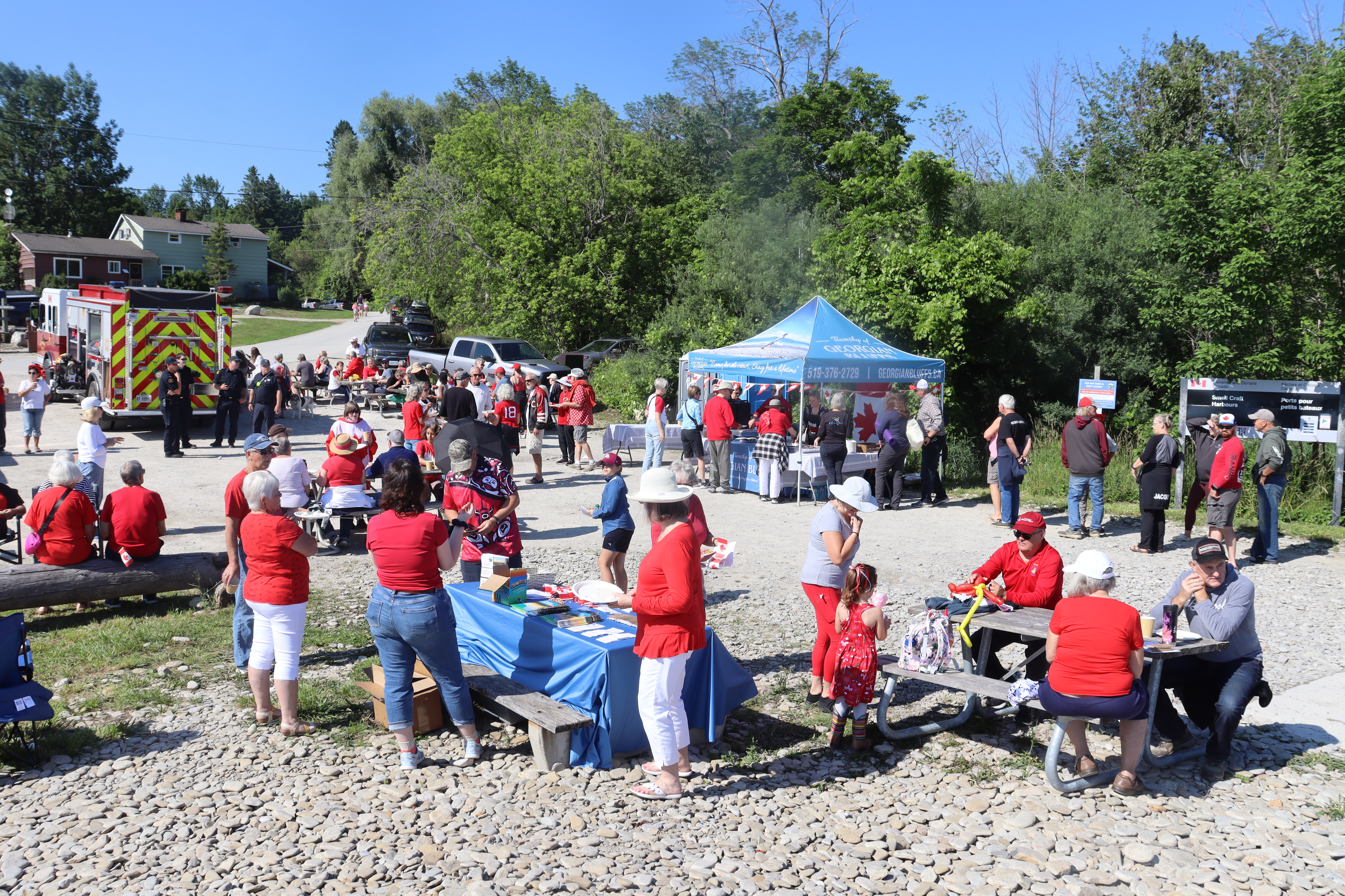 A tent and people dressed in red, celebrating Canada Day